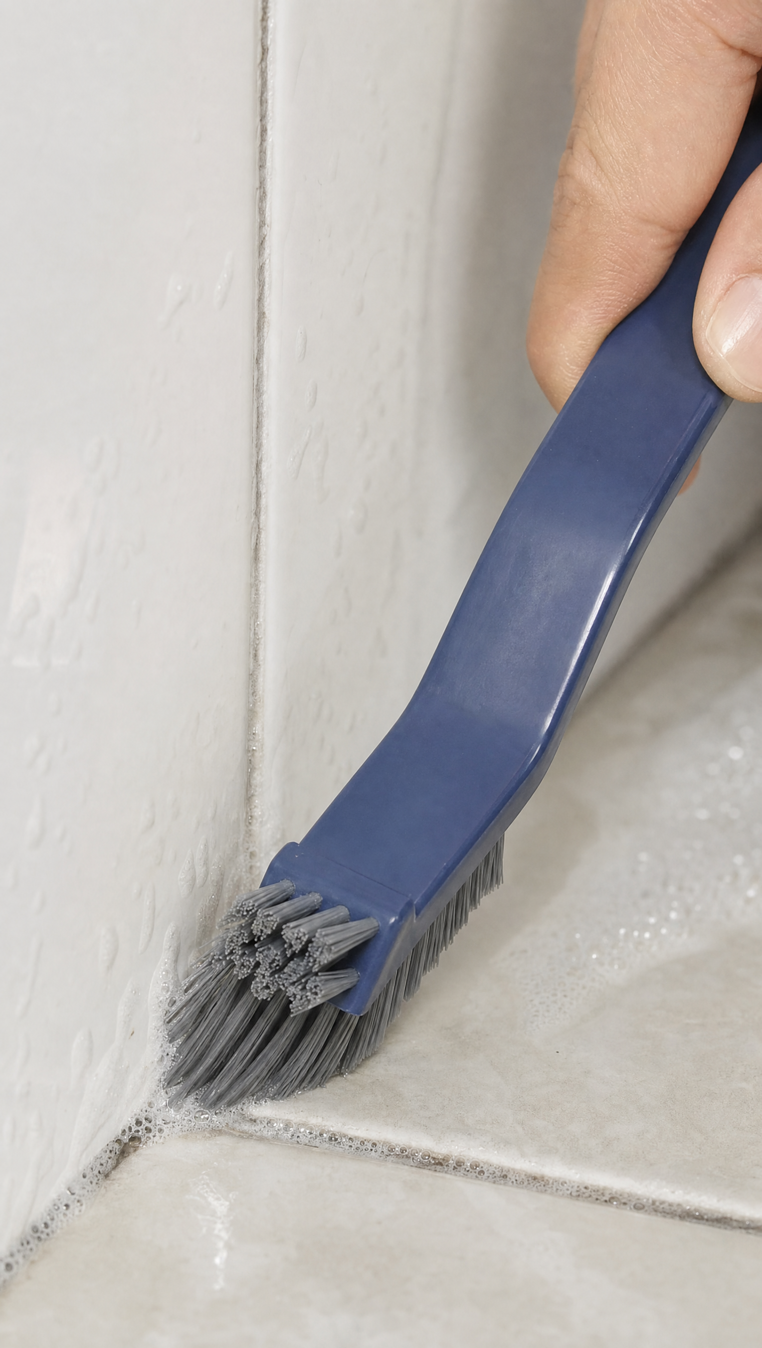 Person using 2-in-1 Corner Cleaning Brush in a realistic lifestyle scene