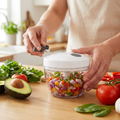 Person using a pull chopper food prep bowl in a kitchen
