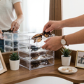 Person placing sunglasses into a stackable organizer
