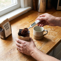 Person measuring coffee grounds with a digital kitchen spoon scale