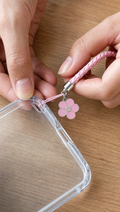 Person using Braided Phone Charm Strap in a realistic lifestyle scene
