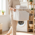 Person carrying clothes in a foldable laundry basket