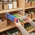 Person sliding an under shelf pull-out basket in a pantry